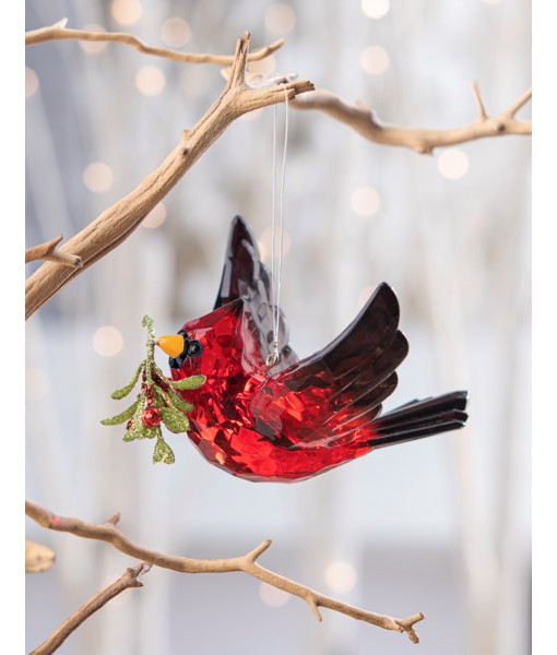 Ornement, cardinal rouge en vol, avec un brin de gui