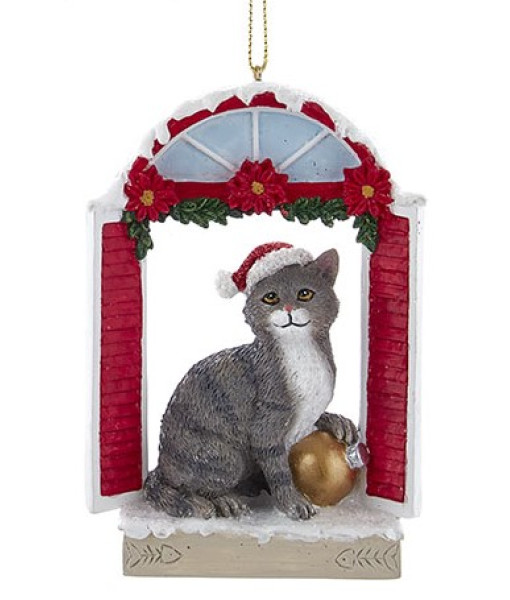 Grey cat with Santa hat in a window frame