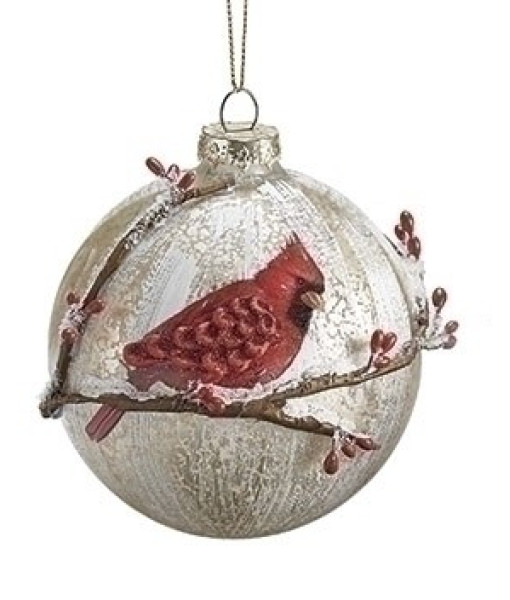 Ornement en verre, avec un cardinal sur une branche hivernale.