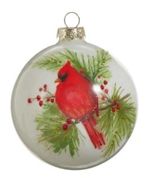 Ornement en forme de boule en verre. Cardinal sur une branche de pin.