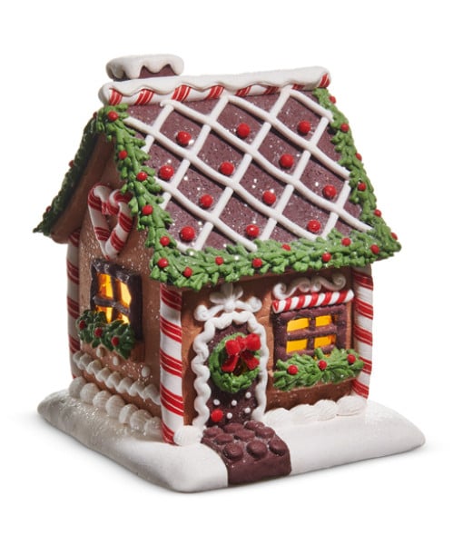 Maison en pain d'épice éclairée avec glaçage au chocolat