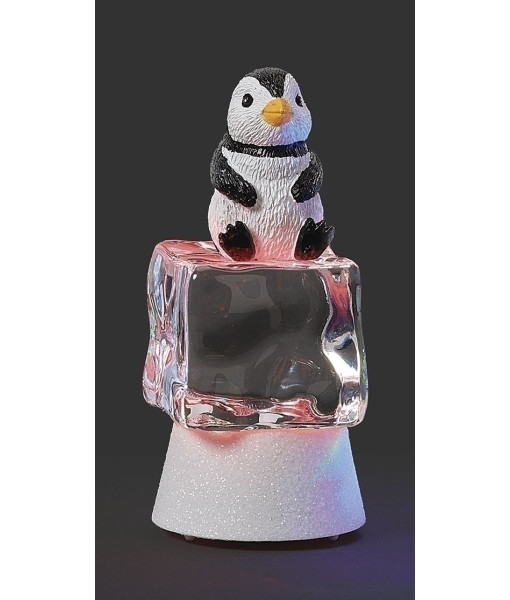 Pièce de table, pingouin illuminé par une lumière scintillante sur un cube de glace rouge