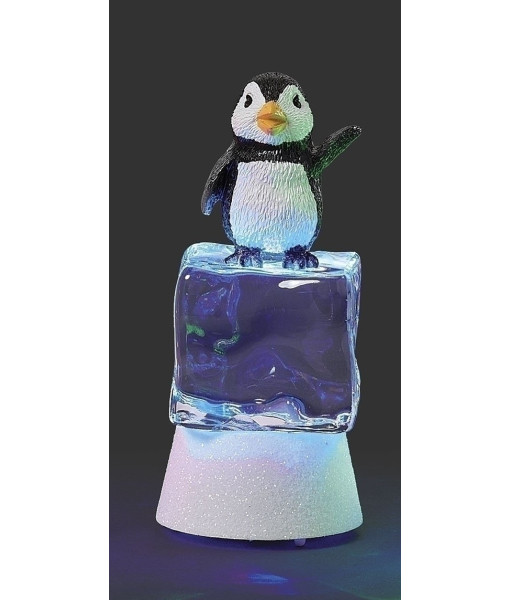 Pièce de table, pingouin illuminé par une lumière scintillante sur un cube de glace bleu