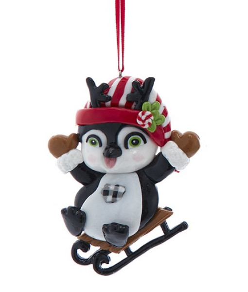 Ornement, petit pingouin festif sur un toboggan
